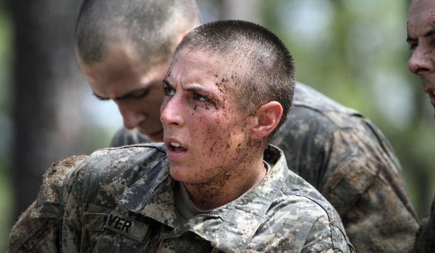 In this April 26, 2015, photo, 1st Lt. Shaye Haver, one of the 20 female soldiers, who is among the 400 students who qualified to start Ranger School, tackles the Darby Queen obstacle course. (Robin Trimarchi/Ledger-Enquirer via AP)