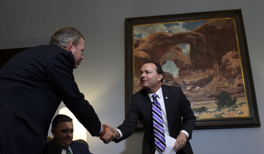 Sen. Mike Lee, R-Utah, right, shakes hands with Dr. Samuel Oliver, president of Union University, left, after participating in a conference call in Lee&#39;s Capitol Hill office in Washington, Wednesday, June 3, 2015, with representatives from religious nonprofits who are concerned about how the Supreme Court&#39;s upcoming gay marriage decision will affect their institutions, and members of the media. Dr. Jerry Johnson, president of the National Religious Broadcasters is center. (AP Photo/Susan Walsh)