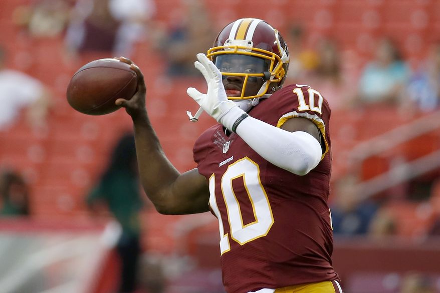 Washington Redskins quarterback Robert Griffin III warms up before a preseason game Thursday against the Detroit Lions in Landover, Md. (Associated Press)