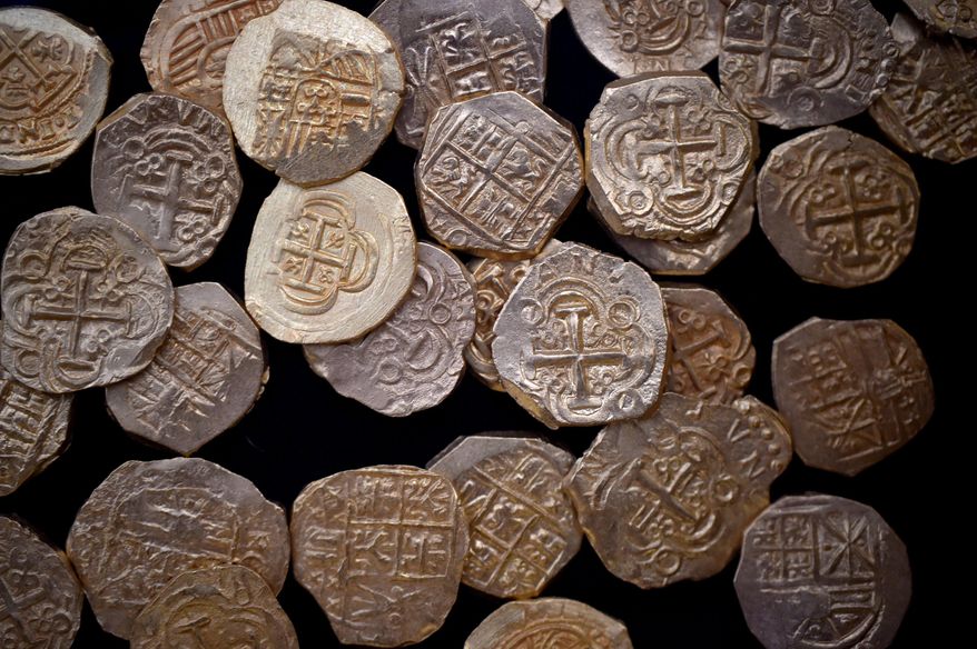 Some of the gold coins valued at $4.5-million found off the coast of Wabasso Beach on July 30-31, 2015 are on display during a news conference Thursday, Aug. 20, 2015 in Sebastian, Fla. The crew of the Capitana from 1715 Fleet - Queens Jewels LLC, discussed their discovery of more than 350 gold coins valued at $4.5-million found on July 30-31, 2015 off the coast of Wabasso Beach. (Eric Hasert/The Stuart News via AP) FLORIDA TODAY OUT; MAGS OUT; MANDATORY CREDIT