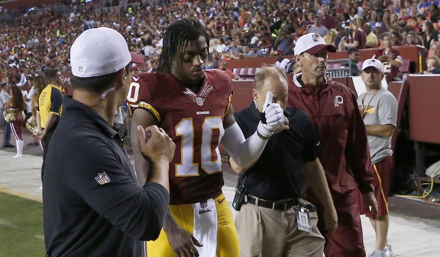 Washington Redskins quarterback Robert Griffin III (10) leaves the field after an injury during the first half of an NFL preseason football game against the Detroit Lions, Thursday, Aug. 20, 2015, in Landover, Md. (AP Photo/Alex Brandon)