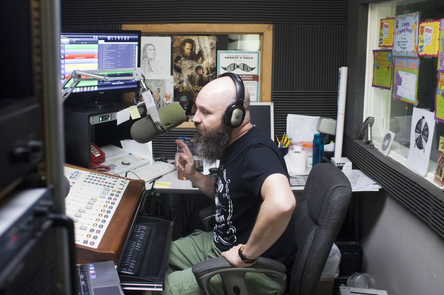 ADVANCE FOR USE SATURDAY, AUG. 22 - In this photo taken, Aug. 12, 2015, J.R. Ramsey, better known as the DJ Dr. Nick Redbone on 103.1 The Edge, works in the recording booth at the Lee Family Broadcasting radio station in Jerome, Idaho. Ramsey said besides having an on-air presence, having an online presence is just as important. That's getting a Facebook page, webpage, Twitter and Instagram accounts, and audio platforms like SoundCloud. (Stephen Reiss/The Times-News via AP) MANDATORY CREDIT