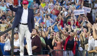 Republican presidential candidate Donald Trump waves to supporters during a campaign rally in Mobile, Ala., on Friday, Aug. 21, 2015. (AP Photo/Brynn Anderson)