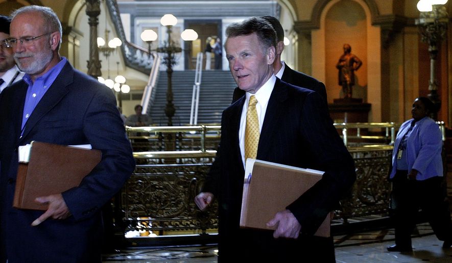 FILE - In a June, 6, 2007 file photo, Illinois Speaker of the House Michael Madigan&#39;s spokesperson Steve Brown, left, walks ahead Madigan, center, past the &amp;quot;brass rail&amp;quot; on his way to Illinois Gov. Rod Blagojevich&#39;s office at the Illinois State Capitol in Springfield, Ill. Brown is a contract employee with outside clients who depend on Madigan and the Legislature for funding, according to a published report. Brown&#39;s clients include a program for nursing assistants that saw its state funding more than double from 2011 to 2013, and a nonprofit group that helps dropouts, which has received $1.6 million in state grants over the past two years, the Chicago Sun-Times reported  (AP Photo/Seth Perlman, File)