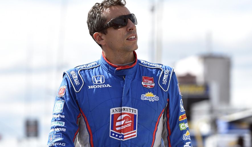 Justin Wilson, of England, walks on pit road during qualifying for Sunday&#39;s Pocono IndyCar 500 auto race, Saturday, Aug. 22, 2015, in Long Pond, Pa. Wilson was injured during Sunday&#39;s race and air lifted to the hospital. (AP Photo/Derik Hamilton)