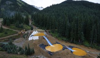 Water flows through a series of retention ponds built to contain and filter out heavy metals and chemicals from the Gold King Mine chemical accident, outside Silverton, Colorado. (Associated Press)