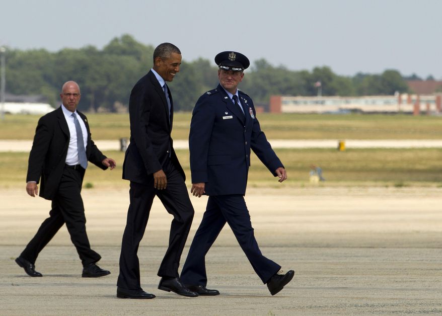 President Barack Obama, accompanied by Commander of the 89th Airlift Wing Colonel John C. Millard, walks towards Air Force One at Andrews Air Force Base in Md., Monday, Aug. 24, 2015, en route to Las Vegas, Nev. where the the President will speak at the National Clean Energy Summit. (AP Photo/Jose Luis Magana)