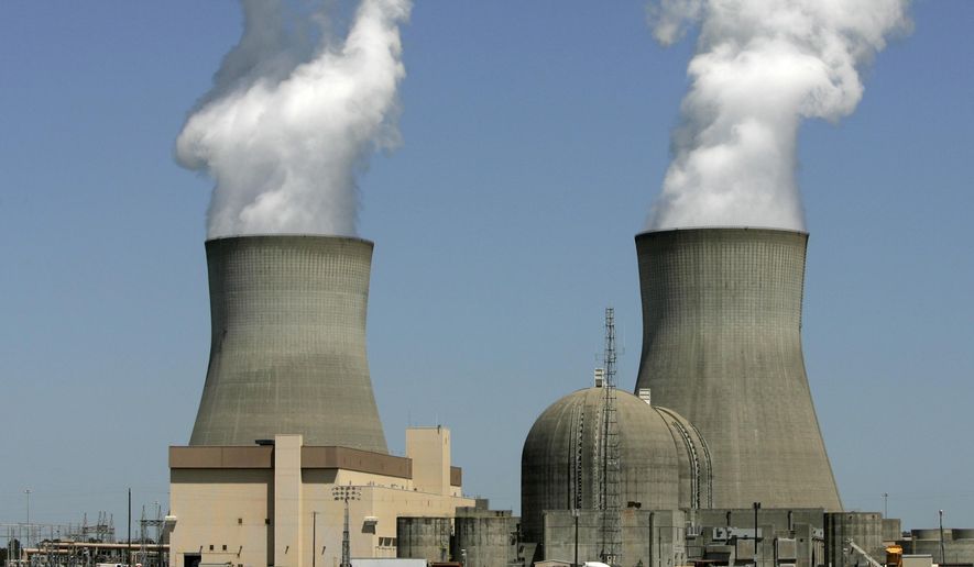 In this April 28, 2010, photo, steam rises from the cooling towers of nuclear reactors at Georgia Power&#39;s Plant Vogtle, in Waynesboro, Ga. Southern Co. is buying AGL Resources Inc. for approximately $7.93 billion, the company announced, Monday, Aug. 24, 2015, which would create the second-biggest utility company in the United States, by customer base. (AP Photo/Mary Ann Chastain, File)