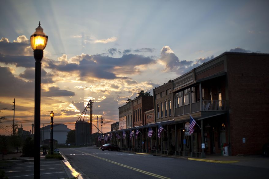 The sun rises behind Main Street in the hometown of former President Jimmy Carter in Plains, Ga., Sunday, Aug. 23, 2015. Carter and his hometown have always been intertwined, from the day he announced he would run for president and an old train depot downtown became a local campaign office. He and his wife, Rosalynn, have always kept a home there, but the 90-year-old Carter intends to spend a lot more time in the tiny town as he’s treated for cancer that has spread to his brain. (AP Photo/David Goldman)