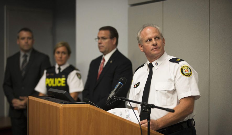 Toronto Police Services Superintendent Bryce Evans, right, speaks to the media regarding the investigation into the AshleyMadison.com breach during a press conference in Toronto on Monday, Aug. 24, 2015. (Melissa Renwick/Toronto Star, The Canadian Press via AP) ** FILE **