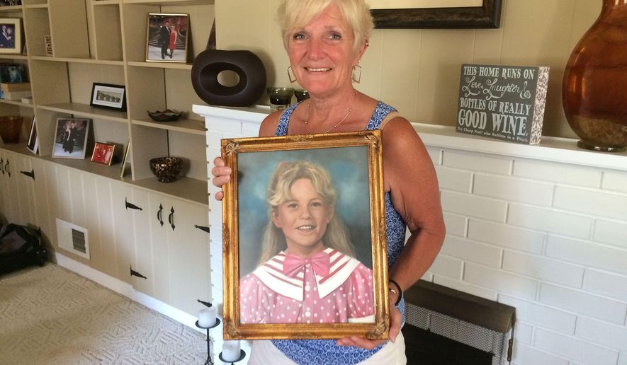 Patty Paulsen holds a portrait of her daughter Sarah in the Paulsen's family home in Portage, Ind., Aug. 11, 2015. The eight-year-old was killed Aug. 22, 1995. Her murder set off a time of fear and togetherness in the city. Her killer, Eugene Britt, was arrested Nov. 3, 1995 and confessed to killing the young girl. He was sentenced to life in prison. He was also linked to the murders and rape of several women in Lake County and pleaded guilty to three of those murders. (Joyce Russell/The Times of Northwest Indiana via AP)