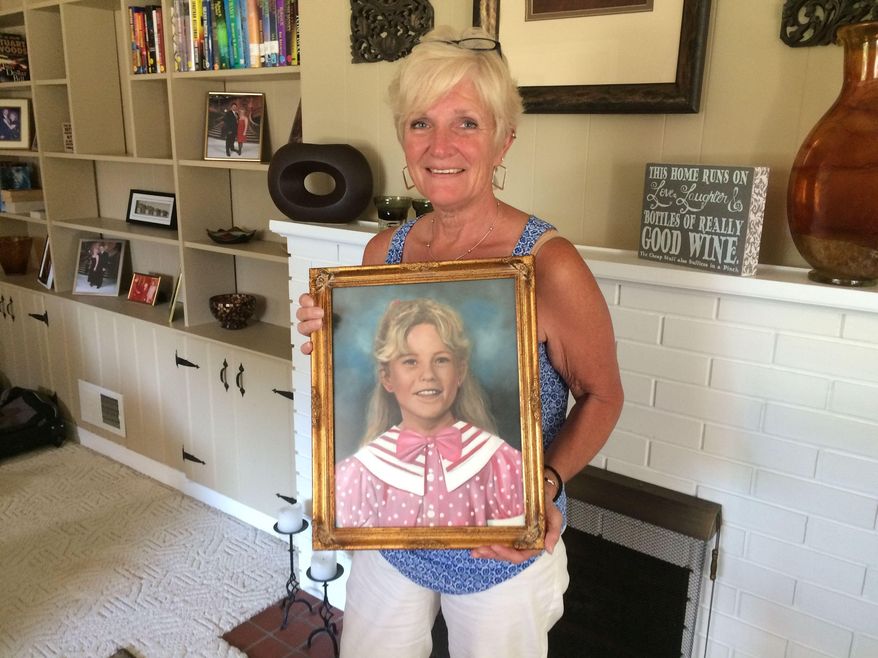 Patty Paulsen holds a portrait of her daughter Sarah in the Paulsen's family home in Portage, Ind., Aug. 11, 2015. The eight-year-old was killed Aug. 22, 1995. Her murder set off a time of fear and togetherness in the city. Her killer, Eugene Britt, was arrested Nov. 3, 1995 and confessed to killing the young girl. He was sentenced to life in prison. He was also linked to the murders and rape of several women in Lake County and pleaded guilty to three of those murders. (Joyce Russell/The Times of Northwest Indiana via AP)