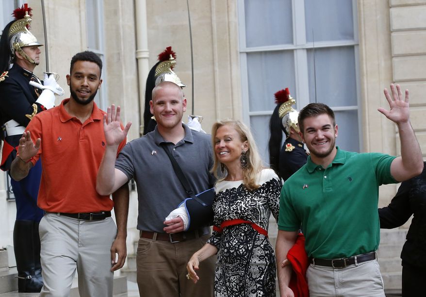From the left, Anthony Sadler, a senior at Sacramento University in California , U.S. Airman Spencer Stone, U.S. Ambassador to France Jane D. Hartley and U.S. National Guardsman from Roseburg, Oregon, Alek Skarlatos, right, arrive at the Elysee Palace, Monday Aug.24, 2015 in Paris, France. (AP Photo/Michel Euler)
