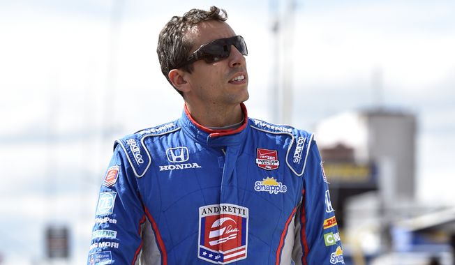 Justin Wilson of England walks on pit road Saturday during qualifying for Sunday&#x27;s Pocono IndyCar 500 in Long Pond, Pa. (Associated Press)