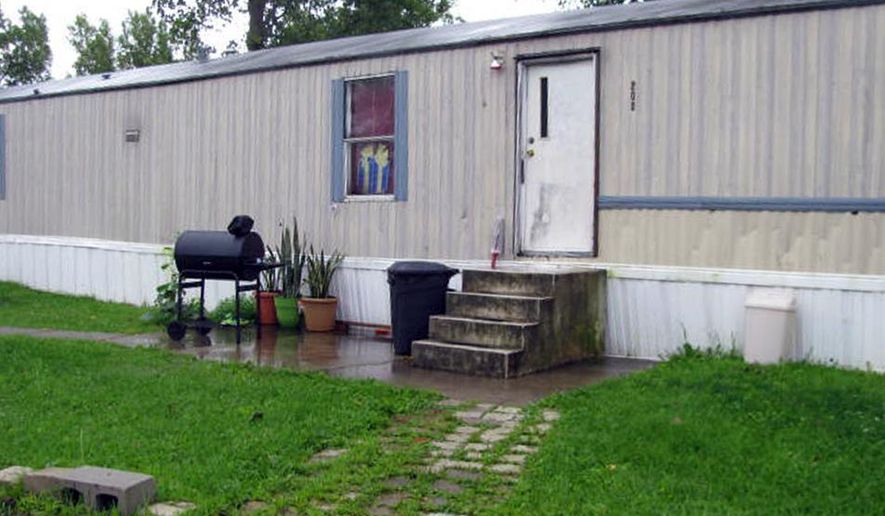 This photo taken July 17, 2015 shows a mobile home that prosecutors say Guatemalan teenagers were forced to live in when they weren’t working at egg farms in Marion, Ohio. Prosecutors say immigrant teenagers brought to Ohio and forced to work long hours on egg farms had been fraudulently plucked from U.S. custody after arriving at the border. (AP Photo/Mitch Stacy)