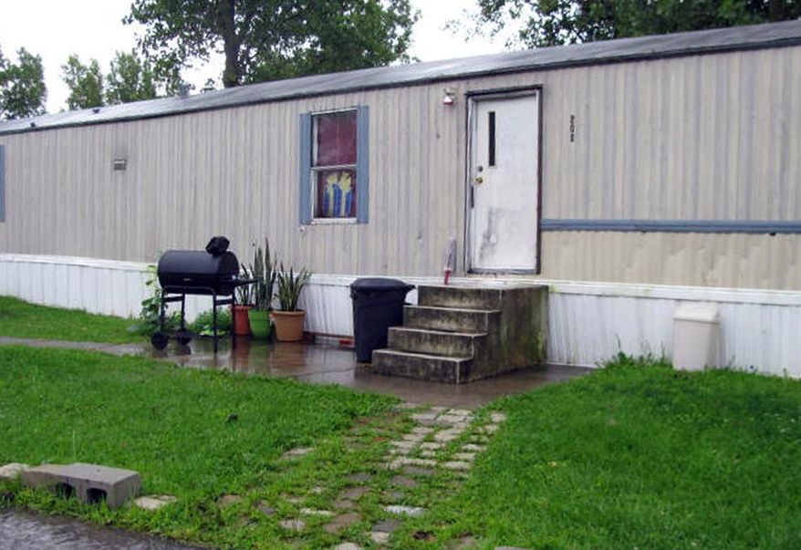 This photo taken July 17, 2015 shows a mobile home that prosecutors say Guatemalan teenagers were forced to live in when they weren’t working at egg farms in Marion, Ohio. Prosecutors say immigrant teenagers brought to Ohio and forced to work long hours on egg farms had been fraudulently plucked from U.S. custody after arriving at the border. (AP Photo/Mitch Stacy)