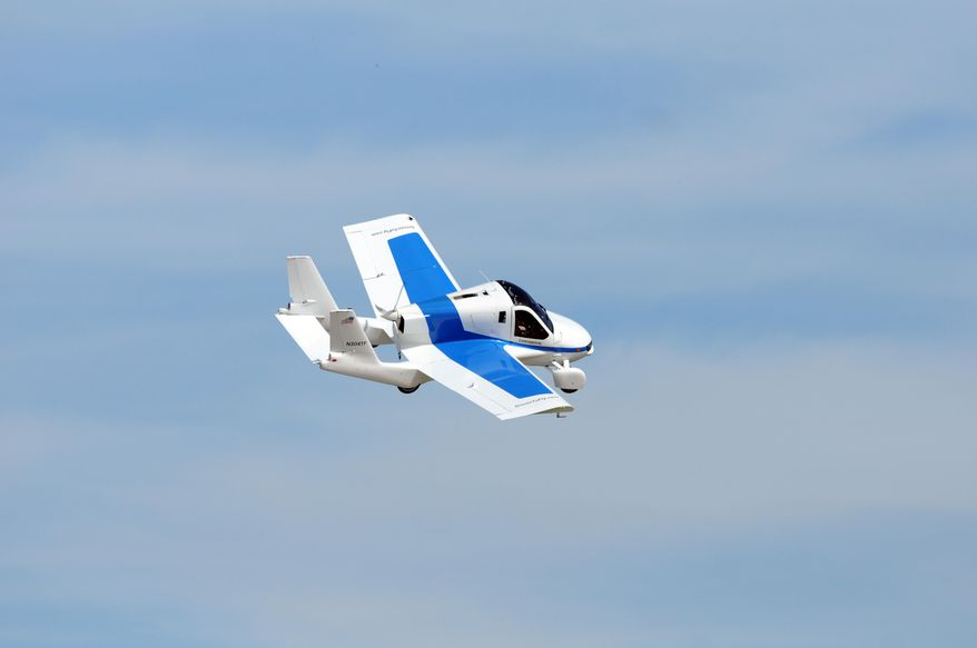 In this Monday, July 29, 2013 photo, the Terrafugia "roadable plane" flies during the Experimental Aircraft Association's AirVenture in Oshkosh, Wis. Terrafugia, a privately backed startup in Woburn, Massachusetts, admits on its website that flying cars have become a pop-culture symbol for dreams that don't come true. CEO Carl Dietrich wants to change that. (Joe Sienkiewicz/The Oshkosh Northwestern via AP) NO SALES; MANDATORY CREDIT
