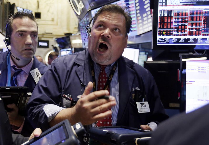 FILE - In this Monday, Aug. 24, 2015, file photo, trader John Santiago, center, works on the floor of the New York Stock Exchange. Conversations Monday with roughly a dozen everyday Americans suggest that people generally expect stock prices to rebound, just as they have after previous swoons. (AP Photo/Richard Drew, File)