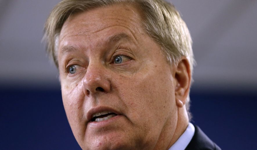 Sen. Lindsey Graham, South Carolina Republican and 2016 presidential hopeful, speaks with local residents during a campaign stop at the Wapello GOP headquarters in Ottumwa, Iowa, on Aug. 19, 2015. (Associated Press) **FILE**