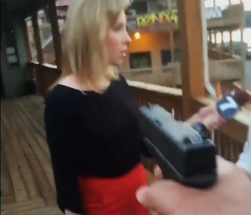 In this framegrab from video posted on Bryce Williams' Twitter account and Facebook page, Williams, whose real name is Vester Lee Flanagan II, aims a gun at WDBJ-TV television reporter Alison Parker as she conducts a live on-air interview in Moneta, Va., on Aug. 26, 2015. Moments later, Flanagan fatally shot Parker and cameraman Adam Ward and injured Vicki Gardner, who was being interviewed. The station said Flanagan was a former employee at WDBJ and appeared on air as Bryce Williams. (Vester Lee Flanagan II/Twitter via Associated Press)