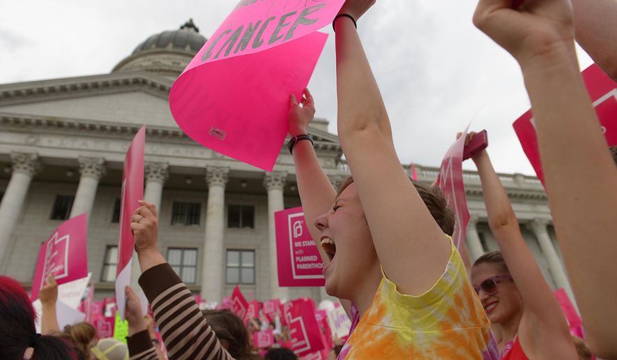 Tori Reichelderfer, 17, shows her support as Planned Parenthood Action Council holds a community rally at the state Capitol in Salt Lake City on Aug. 25, 2015. Planned Parenthood Association of Utah CEO Karrie Galloway says the demonstration is a protest against Gov. Gary Herbert&#x27;s decision to stop disbursing federal money to Planned Parenthood. (Leah Hogsten/The Salt Lake Tribune via AP) **FILE**