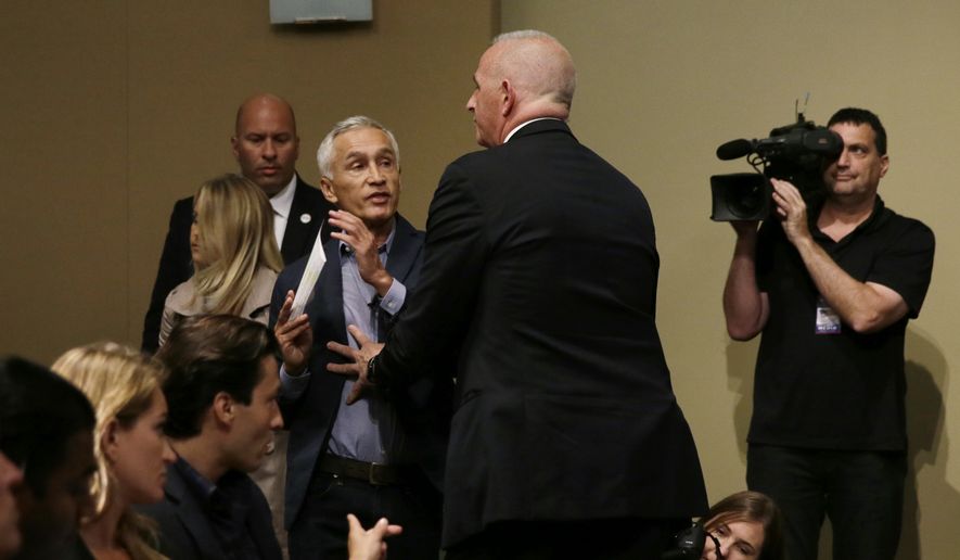 A security guard for Republican presidential candidate Donald Trump removes Miami-based Univision anchor Jorge Ramos from a news conference, Tuesday, Aug. 25, 2015, in Dubuque, Iowa. Ramos stood up and began to ask Trump about his immigration proposal. (AP Photo/Charlie Neibergall)