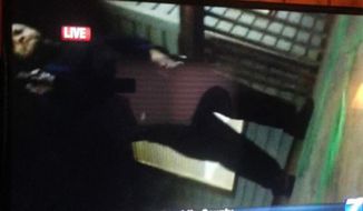 In this framegrab from video made by the camera of WDBJ-TV cameraman Adam Ward, Vester Lee Flanagan II stands over Mr. Ward with a gun after fatally shooting him and reporter Alison Parker on Wednesday during a live on-air interview in Moneta, Va. (Twitter via Associated Press)