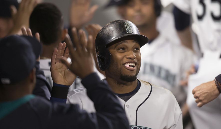 Seattle Mariners&#39; Robinson Cano is congratulated by teammates after scoring during the fifth inning of a baseball game against the Oakland Athletics, Tuesday, Aug. 25, 2015, in Seattle. (AP Photo/Stephen Brashear)