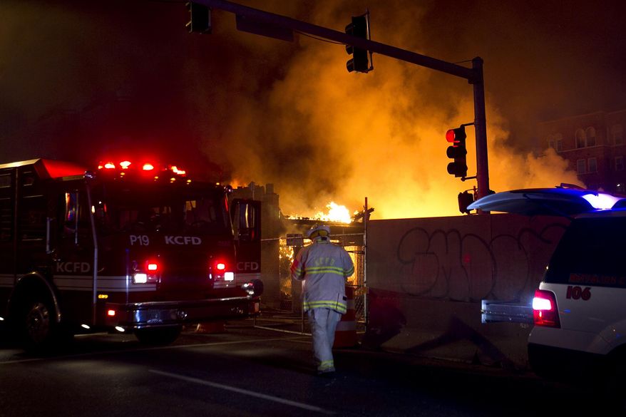 FILE - In a Feb. 19, 2013 file photo, firefighters are on the scene of a gas explosion and massive fire at JJ's restaurant at the Country Club Plaza in Kansas City, Mo. Jurors ruled Thursday, Aug. 27, 2015, that Time Warner Cable must pay nearly $6 million as part of a lawsuit alleging it was largely responsible for a fatal natural gas explosion that leveled the upscale Kansas City restaurant, JJ's. Brothers David and Jimmy Frantze's lawsuit was among several that were filed following the February 2013 explosion, which killed restaurant worker Megan Cramer and injured more than a dozen other people.(Tammy Ljungblad/The Kansas City Star via AP)