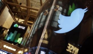 In this Nov. 6, 2013, file photo, the Twitter bird logo is on an updated phone post on the floor of the New York Stock Exchange. (AP Photo/Richard Drew) ** FILE **
