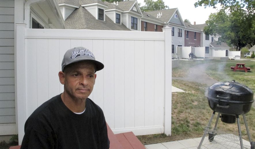Luis Vazquez, a 49-year-old Navy veteran who was homeless off and on for 10 years, sits outside his home in a veterans' housing complex Thursday, Aug. 27, 2015, in Newington, Conn. U.S. Veterans Affairs Secretary Robert McDonald and Connecticut officials were at the housing complex Thursday to announce that the state is the first in the country to end chronic homelessness among veterans. (AP Photo/Dave Collins)