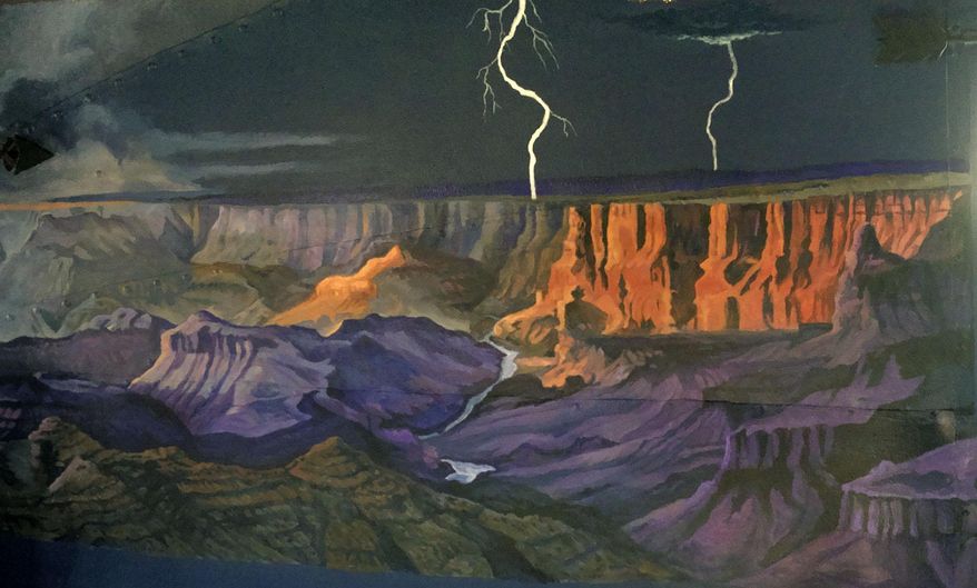 In this Aug. 11, 2015 photo, artist Janet Bedford of Powell, Wyo., painted the bedroom walls of an Airstream trailer into a night scene with stormy skies, cowboy campfires, the Grand Canyon and Old Faithful in the moonlight, in Powell, Wyo. Camping is an art, they say, and Powell artist Janet Bedford is transforming a camper trailer into a literal work of art. Bedford is painting the concave interior walls of a vintage 1948 Airstream trailer into a colorful canvas depicting scenes from national parks across the country. (Matt Naber/The Powell Tribune via AP) MANDATORY CREDIT