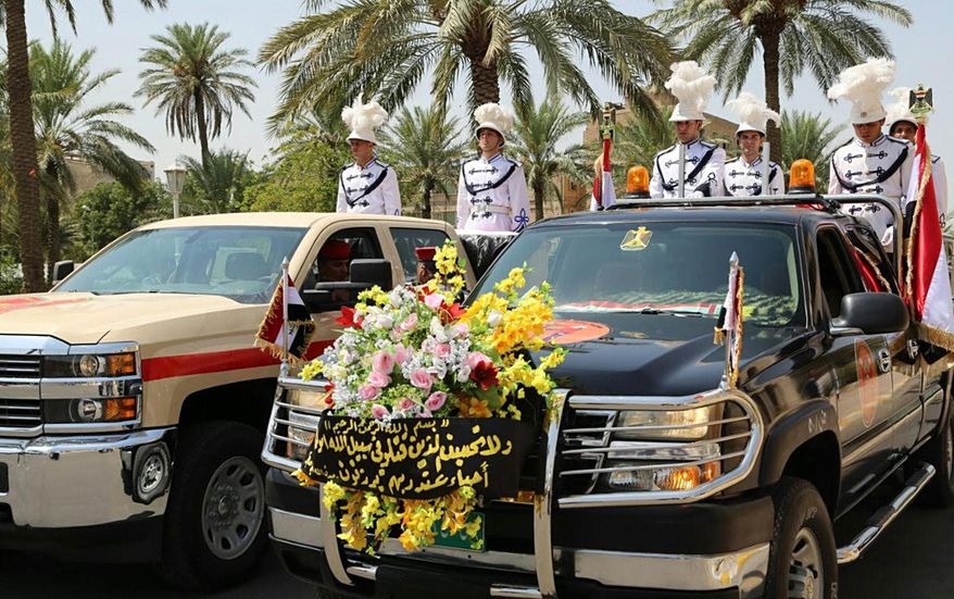 Iraqi honor guards escort the coffins of Maj. Gen. Abdul-Rahman Abu-Regheef, deputy chief of operations in Anbar and Brig. Gen. Sefeen Abdul-Maguid, commander of the 10th Army Division who was killed in Ramadi during fighting with Islamic State militants, during the funeral procession at the headquarters of the Iraqi Ministry of Defense in Baghdad, Iraq, Thursday, Aug. 27, 2015. An Islamic State suicide bomber killed two Iraqi army generals on Thursday as they led forces against IS positions in the turbulent Anbar province west of Baghdad, military officials said. (AP Photo)