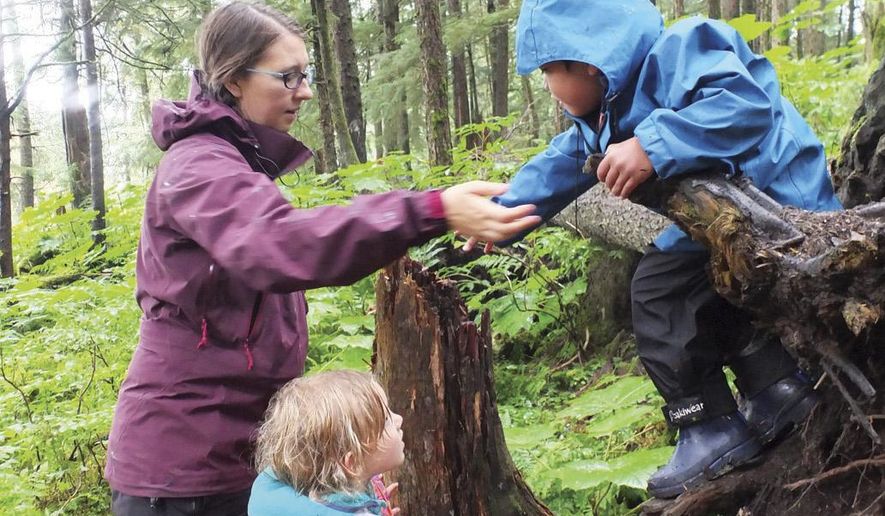 ADVANCE FOR WEEKEND OF SUNDAY, AUG. 30, 2015 AND THEREAFTER. In this Wednesday Aug. 19, 2015 photo, Jennifer Walker, left, works with William Olmstead, right, and Nina Hollatz at the Forest Song Nature School in Juneau, Alaska. The school is a “forest kindergarten” program Walker started to help provide three- to six-year-olds — her own son among them — with nature-based early education. The program hails from Europe, where there are a number of them, and they are now spreading to the United States. (Mary Catharine Martin/ Juneau Empire via AP)