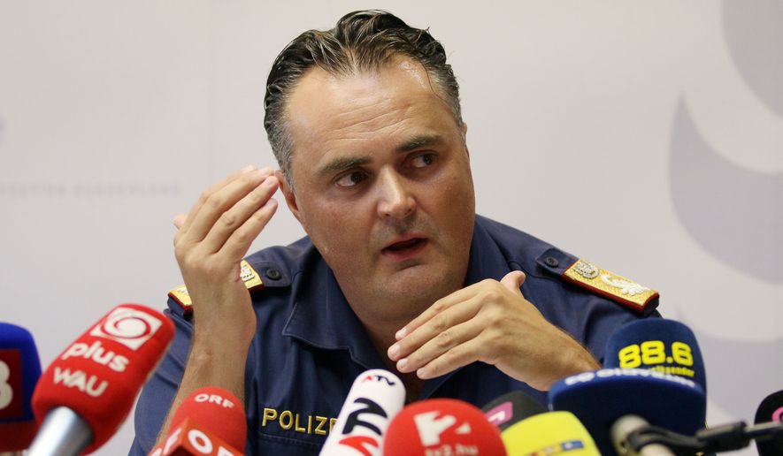 Chief of the Burgenland police, Hans Peter Doskozil, informs the media at a news conference at a police station in Eisenstadt, Austria, Thursday, Aug 27, 2015. Austrian police on Thursday discovered the badly decomposing bodies of at least 20 — and possibly up to 50 — migrants stacked in a truck parked on the shoulder of the main highway from Budapest to Vienna. (AP Photo/Ronald Zak)