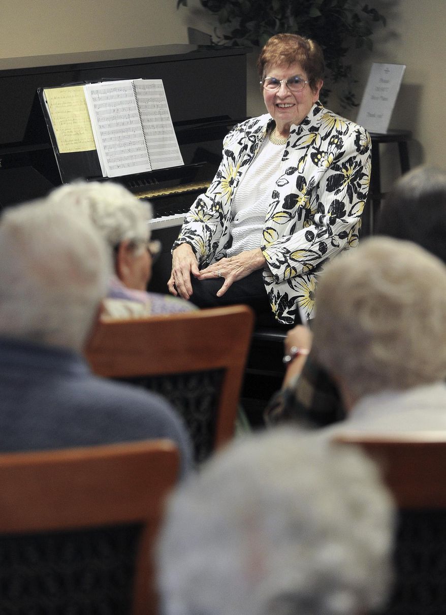 ADVANCE FOR WEEKEND EDITIONS AUG. 29-30 - In this Aug. 10, 2015 photo, Dollie McKenzie gets song request from her fellow residents at MorningStar Senior Living Center in Idaho Falls, Idaho. It's been more than 80 years, but Dollie McKenzie still remembers her first piano lessons. In February, McKenzie chose to celebrate the start of her tenth decade of life fittingly — with a public music program featuring a performance from McKenzie herself along with her daughter, Rexburg-based musician Beverly Solomon, and her granddaughter, Jenny Solomon. (Monte LaOrange/The Idaho Post-Register via AP) MANDATORY CREDIT