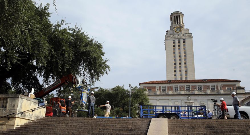A statue of Confederate President Jefferson Davis is moved from its location in front of the school&#x27;s main tower at the University of Texas campus, Sunday, Aug. 30, 2015, in Austin, Texas. The Davis statue, which has been targeted by vandals and had come under increasing criticism, will be moved and placed in the school&#x27;s Dolph Briscoe Center for American History as part of an educational display. (AP Photo/Eric Gay)