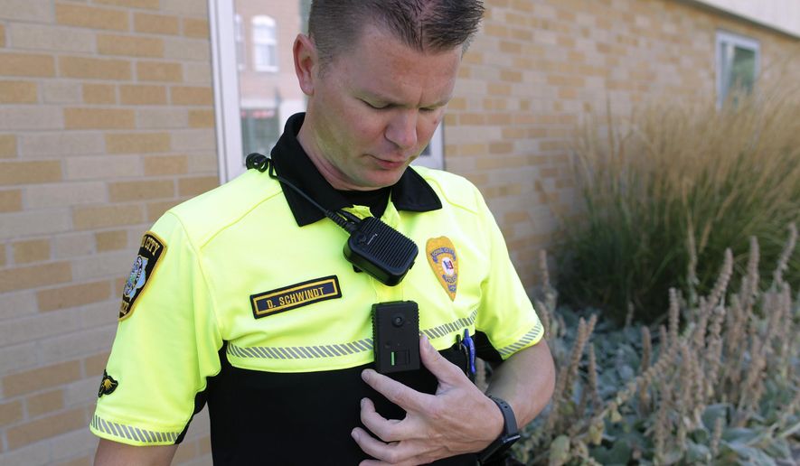 ADVANCE FOR WEEKEND EDITIONS AUG. 29-30 - In this Aug. 13, 2015 photo, Iowa City Police officer David Schwindt displays his body camera in Iowa City, Iowa. Every officer in the Iowa City Police Department is now equipped with a body camera, and police have a new policy governing their use. (David Scrivner/Iowa City Press-Citizen via AP) NO SALES; MANDATORY CREDIT