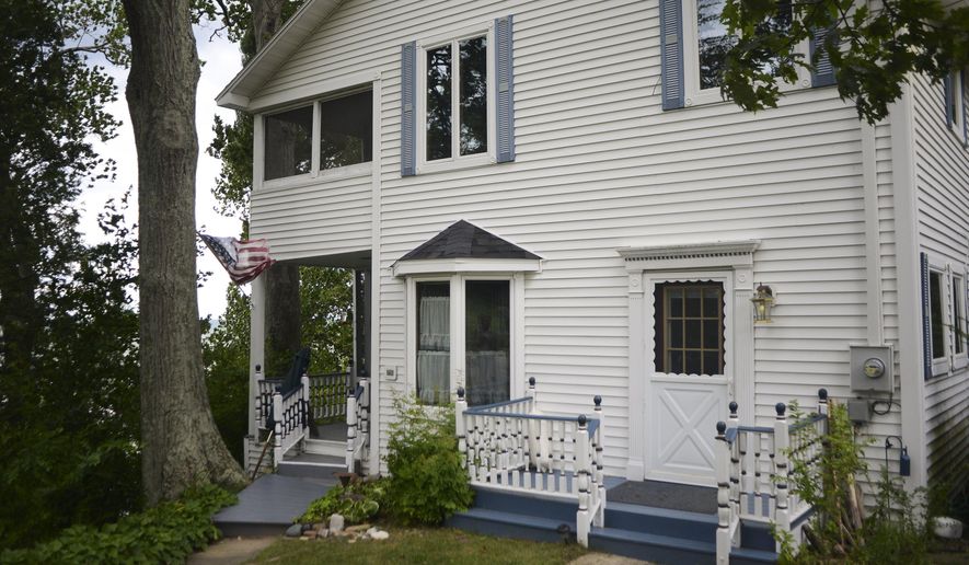 The Sunset Lodge property in Glenn, Mich., is on the market at an asking price of $1.5 million. The property features two historic houses, a chapel and 150 feet of private beach. The property comes with 252 feet of Lake Michigan beach, 50 miles southwest of Grand Rapids. The lodge opened in 1903 with guests arriving by boat from Chicago. (Alex McDougall/The Grand Rapids Press via AP)