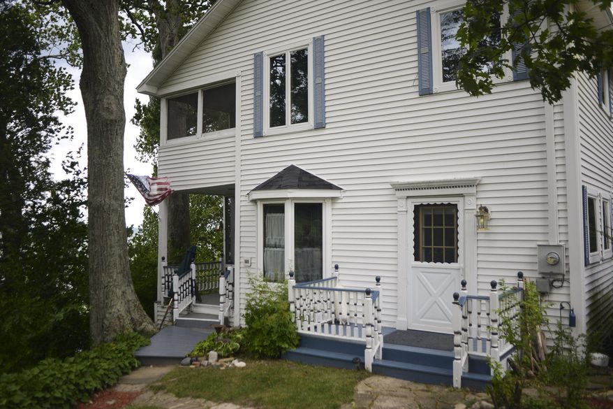 The Sunset Lodge property in Glenn, Mich., is on the market at an asking price of $1.5 million. The property features two historic houses, a chapel and 150 feet of private beach. The property comes with 252 feet of Lake Michigan beach, 50 miles southwest of Grand Rapids. The lodge opened in 1903 with guests arriving by boat from Chicago. (Alex McDougall/The Grand Rapids Press via AP)