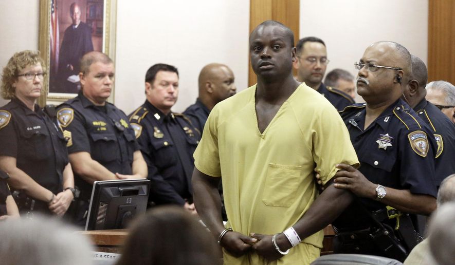 Shannon Miles is escorted out of a courtroom after a hearing, Monday, Aug. 31, 2015, in Houston. Miles has been charged with capital murder in the death of Harris County Sheriff's Deputy Darren Goforth. He is being held without bond. (AP Photo/Pat Sullivan)