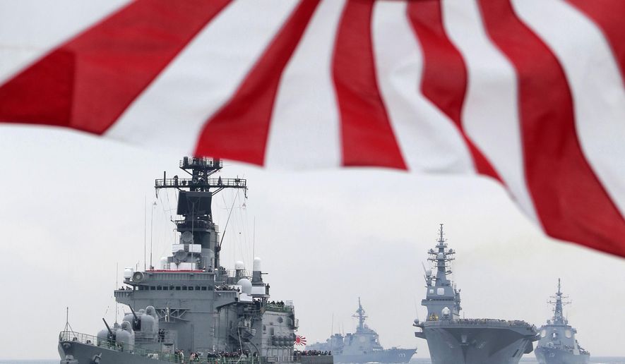 FILE - In this Oct. 14, 2012, file photo, Japan Maritime Self-Defense Force (JMSDF) escort ship Kurama leads other vessels during a fleet review in waters off Sagami, south of Tokyo. Japan's Defense Ministry wants to buy an advanced Aegis radar-equipped destroyer and more F-35 fighters under its largest-ever budget to bolster the defense of southern islands amid a territorial dispute with China. The ministry endorsed a 5.1 trillion yen ($42 billion) budget request Monday, Aug. 31, 2015 for the year beginning next April, up 2.2 percent from this year. It would be the fourth annual increase under Japanese Prime Minister Shinzo Abe, who took office in December 2012 and ended 10 years of defense budget cuts. (AP Photo/Itsuo Inouye, File)