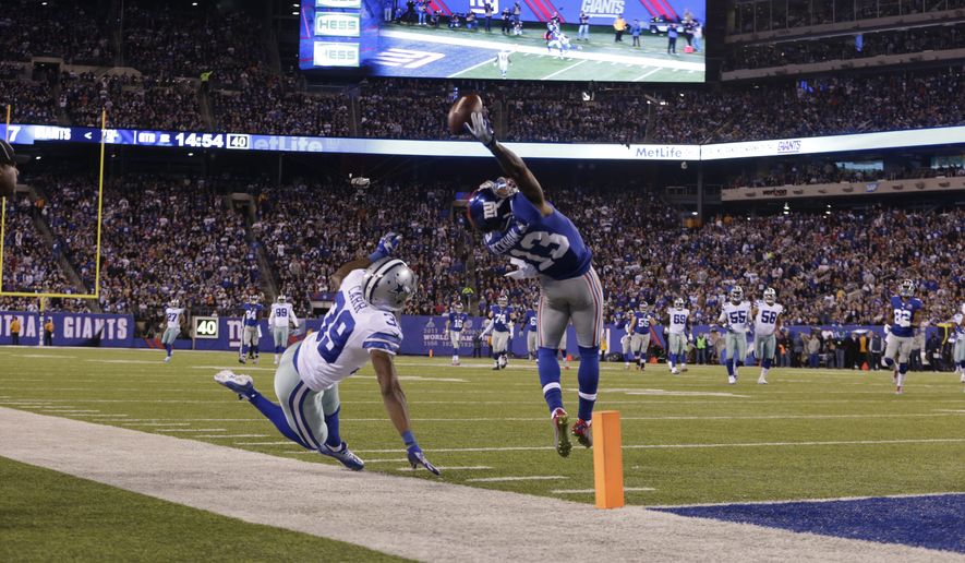 New York Giants wide receiver Odell Beckham (13) makes a one-handed catch for a touchdown against Dallas Cowboys cornerback Brandon Carr (39) in the second quarter of an NFL football game, Sunday, Nov. 23, 2014, in East Rutherford, N.J. (AP Photo/Julio Cortez)
