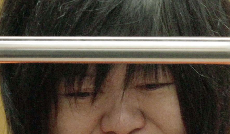FILE - This March 16, 2012 file photo, Dr Lisa Tseng cries during her arraignment in court in Los Angeles. Attorneys are set to deliver opening statements Monday, Aug. 31, in the trial of Tseng, charged with murder the deaths of three young men who overdosed on prescription pain killers. Tseng has pleaded not guilty to three counts of second-degree murder. She could face up to life in prison if convicted on all the charges against her. (AP Photo/Nick Ut, File)
