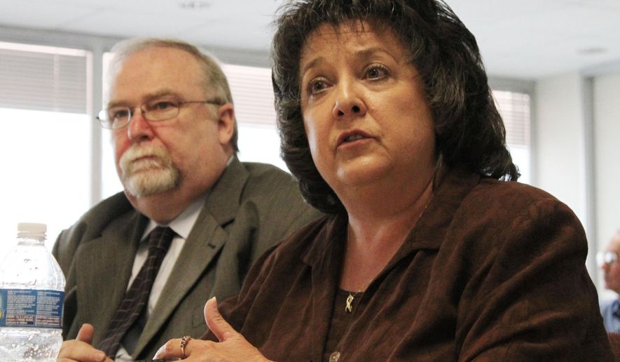 FILE - In this July 16, 2011, file photo, New Mexico Secretary of State Dianna Duran, right, talks during an interim legislative committee hearing in Albuquerque, N.M. Democratic leaders in the New Mexico House of Representatives are raising the possibility of impeachment proceedings against Duran, the state's top elections official, after allegations of fraud, embezzlement and money laundering were leveled against her. (AP Photo/Susan Montoya Bryan, File)