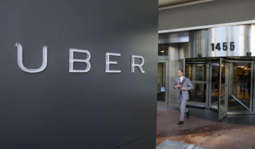 FILE - In this photo taken Tuesday, Dec. 16, 2014, a man leaves the headquarters of Uber in San Francisco. A federal judge granted class-action status Tuesday, Sept. 1, 2015, to a lawsuit in California against Uber over the payment of its drivers, upping the stakes for the ride-hailing company in the case. (AP Photo/Eric Risberg, File)