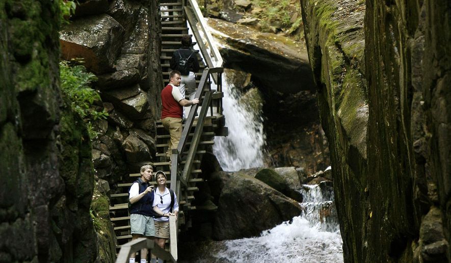FILE - In this Sept. 24, 2007 file photo, Gov. John Lynch, and his wife, Susan Lynch stand in the Flume Gorge in the heart of New Hampshire’s White Mountain National Forest. The gorge’s granite walls stretch nine stories skyward. (AP Photo/Jim Cole, File)