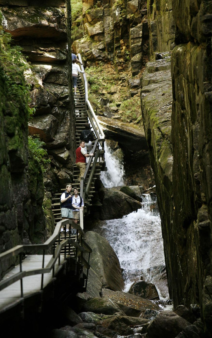 FILE - In this Sept. 24, 2007 file photo, Gov. John Lynch, and his wife, Susan Lynch stand in the Flume Gorge in the heart of New Hampshire’s White Mountain National Forest. The gorge’s granite walls stretch nine stories skyward. (AP Photo/Jim Cole, File)