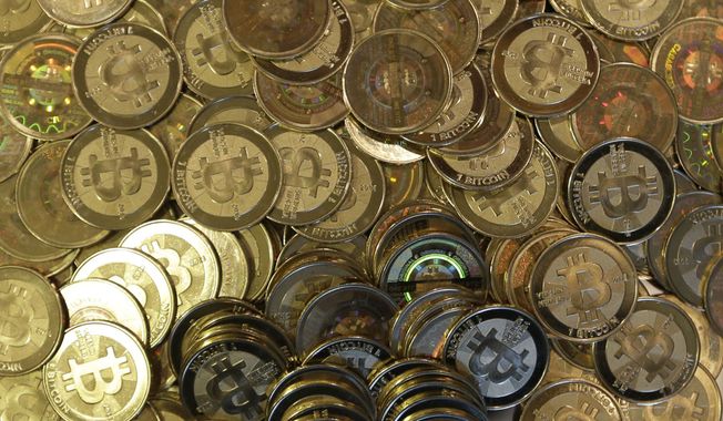 This April 3, 2013, file photo shows bitcoin tokens in Sandy, Utah. (Associated Press/File)