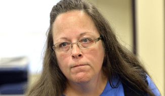 Rowan County Clerk Kim Davis listens to a customer following her office&#39;s refusal to issue marriage licenses at the Rowan County Courthouse in Morehead, Ky., Tuesday, Sept. 1, 2015. Although her appeal to the U.S. Supreme Court was denied, Davis still refuses to issue marriage licenses. (AP Photo/Timothy D. Easley)